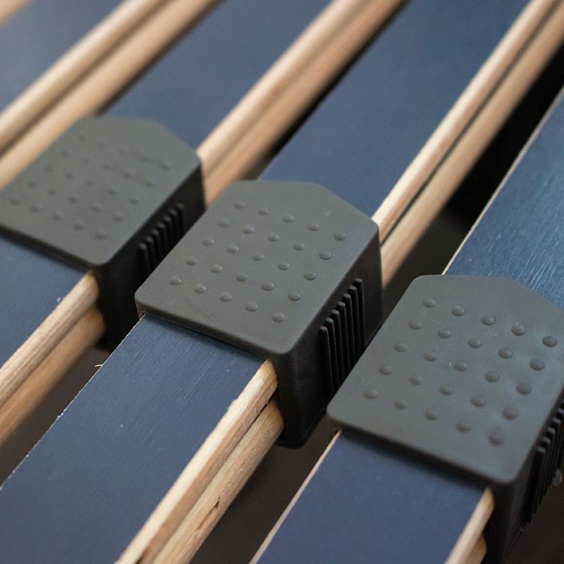 This image shows the sliding adjustment strips on the bed frame